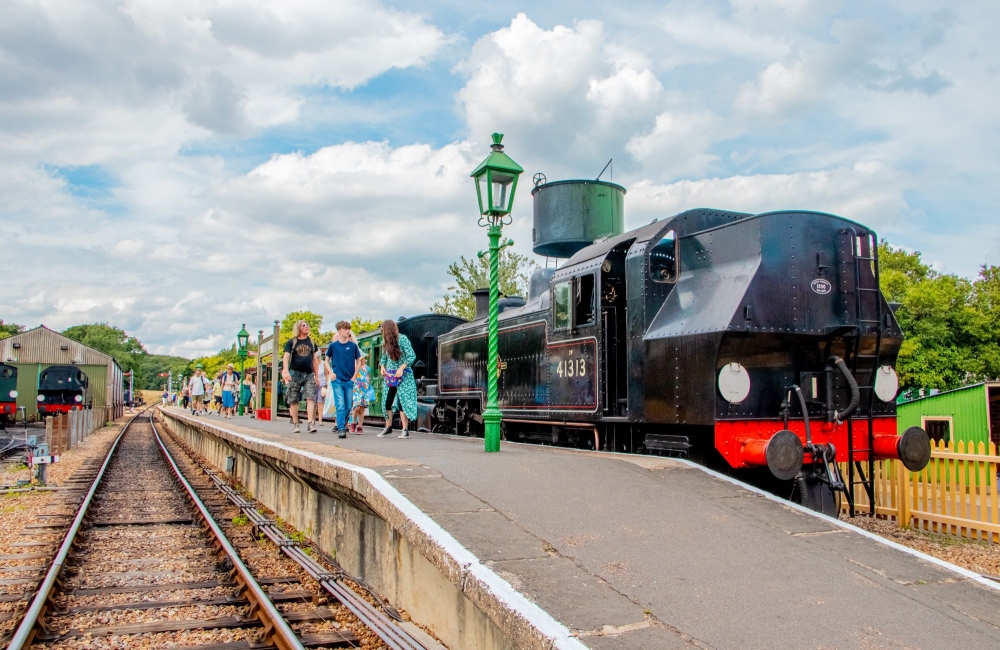 people getting off of the steam railway train