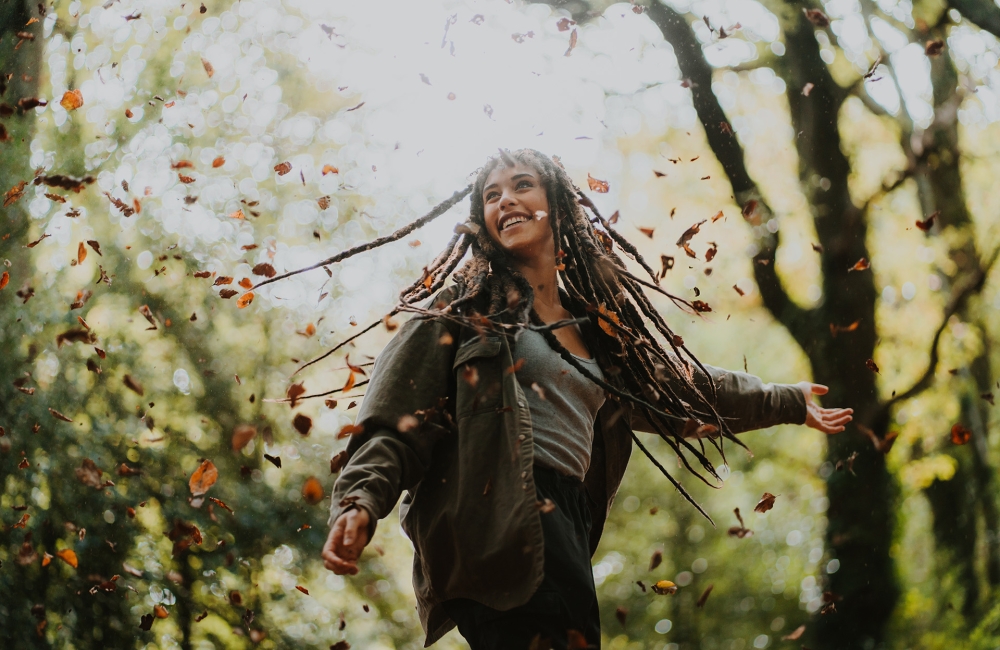 Woman spinning in the forest 