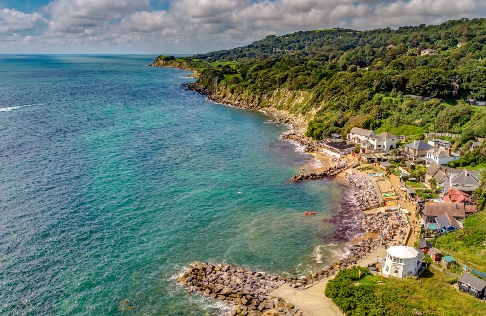 blue sea with stony beach taken from the sky