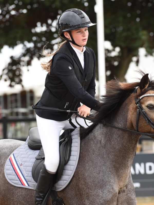 Close up of Rubi riding her pony