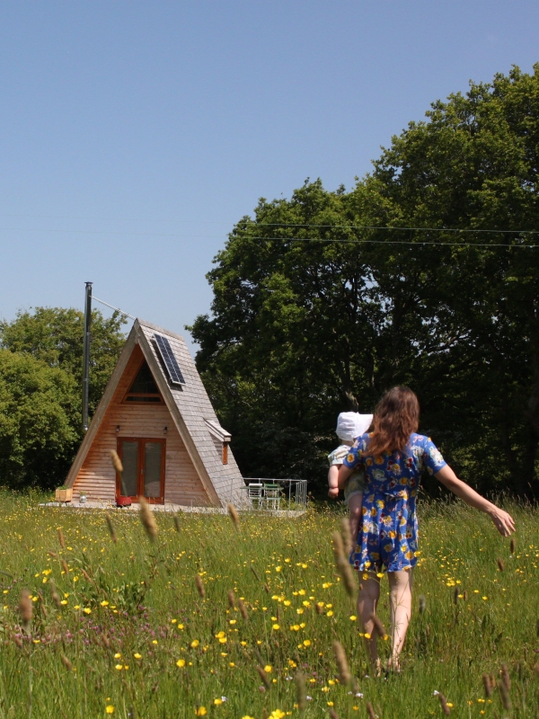 Tiny Homes Holidays a woman holding a child walking towards Silva