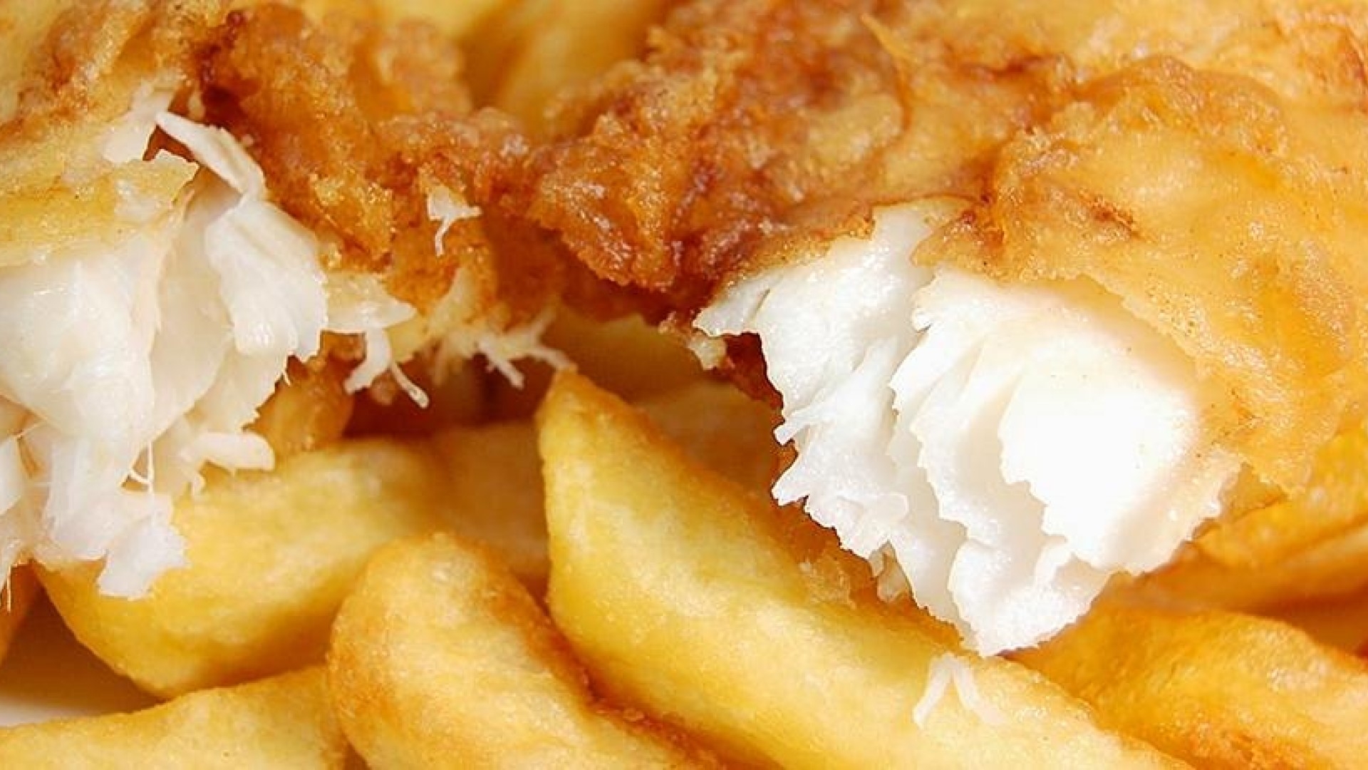 battered white fish on top of golden chips