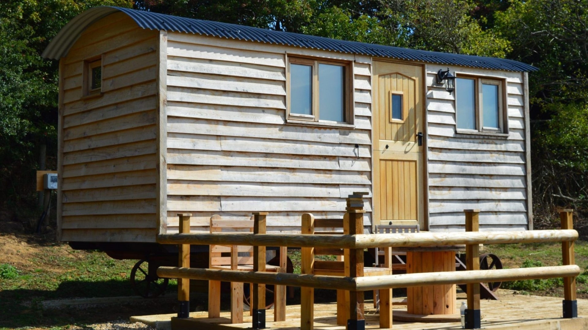 a wooden shepherds hut with external decking area