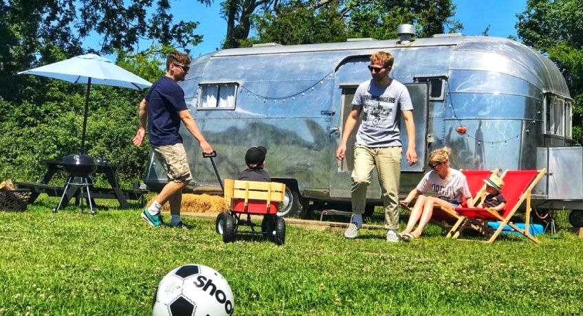 Family having fun outside an airstream