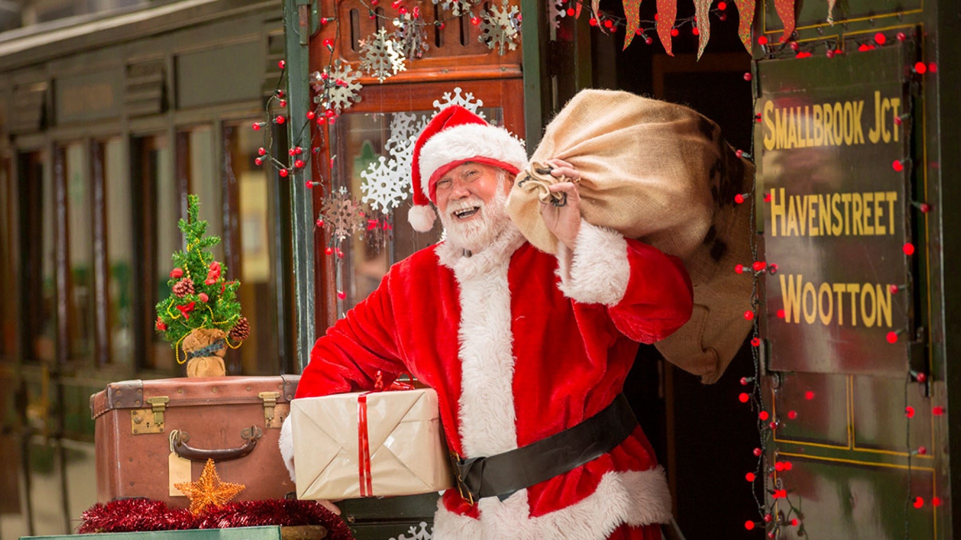 father christmas carrying a sack of toys at the station