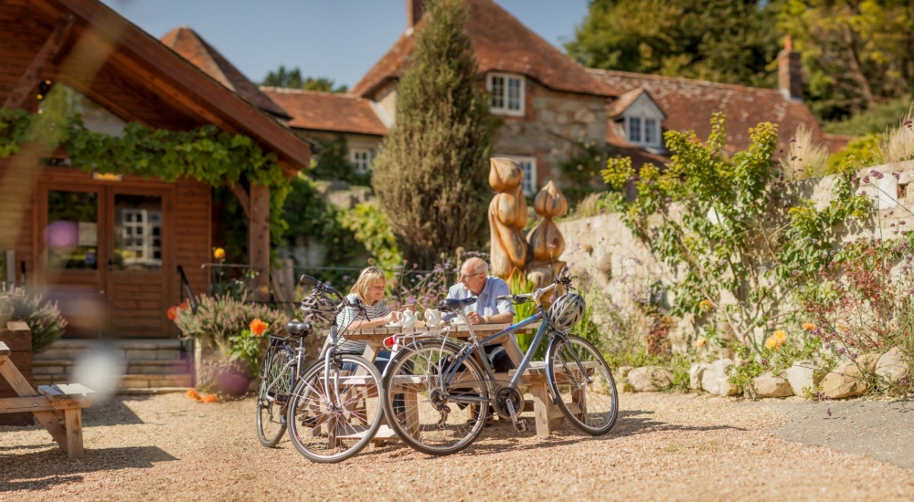 Couple sitting outside eating at the Garlic Farm