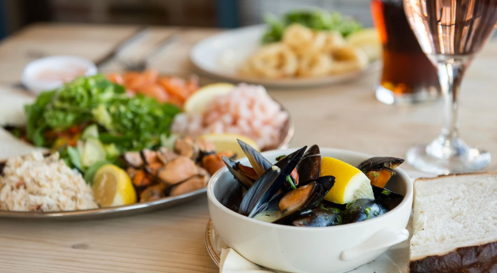 mussels with a platter containing crab, prawn and salad