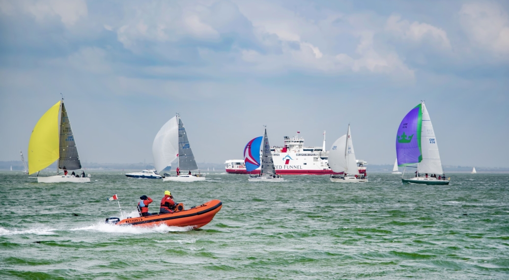 Cowes Week sailing with Red Funnel Ferry in background