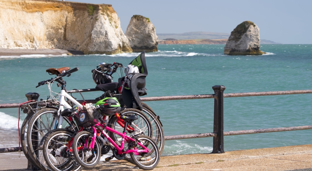 bicycles leaning against railings with freshwater rocks in the background